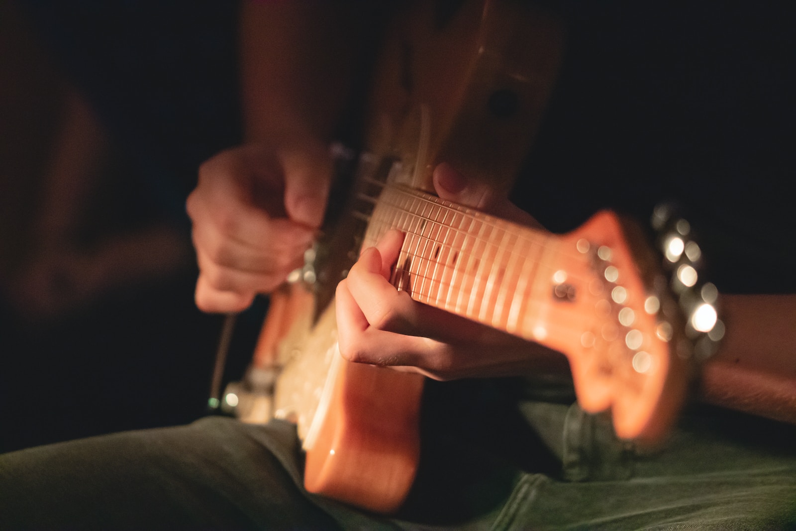 a close up of a person playing a guitar