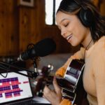woman in brown sweater wearing headphones
