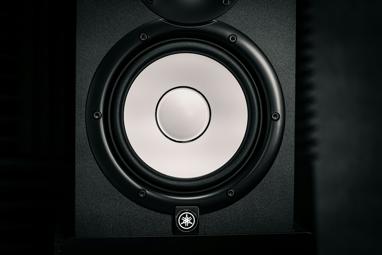 a close up of a speaker in a dark room