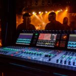 a mixing desk with a laptop on top of it