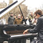 man playing piano in public place