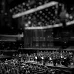 grayscale photography of orchestra playing on theatre