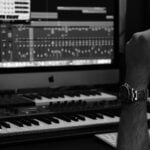 grayscale photo of person playing piano